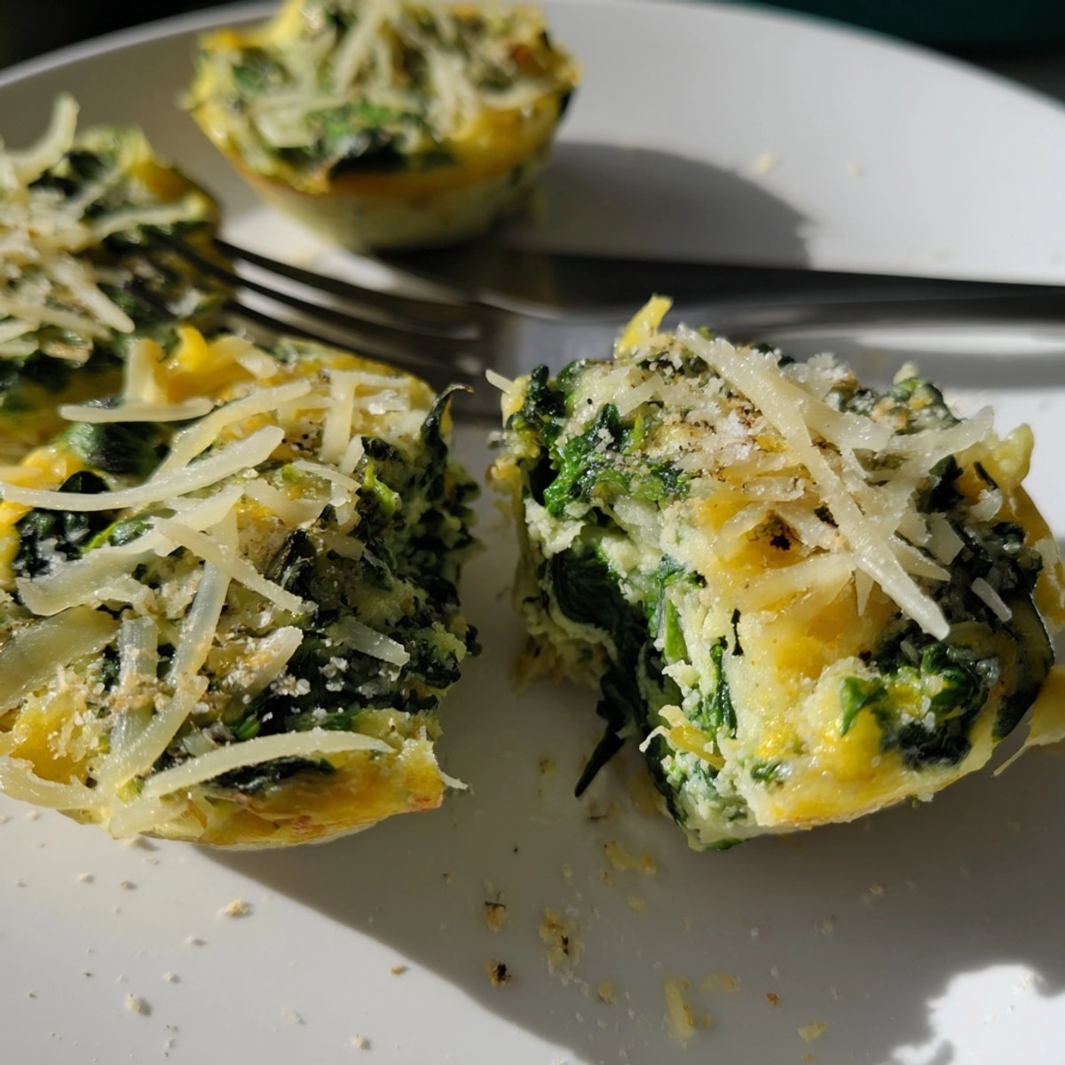 Close-up of a perfectly baked Garlic Butter Spinach Egg Cup, ready to eat.