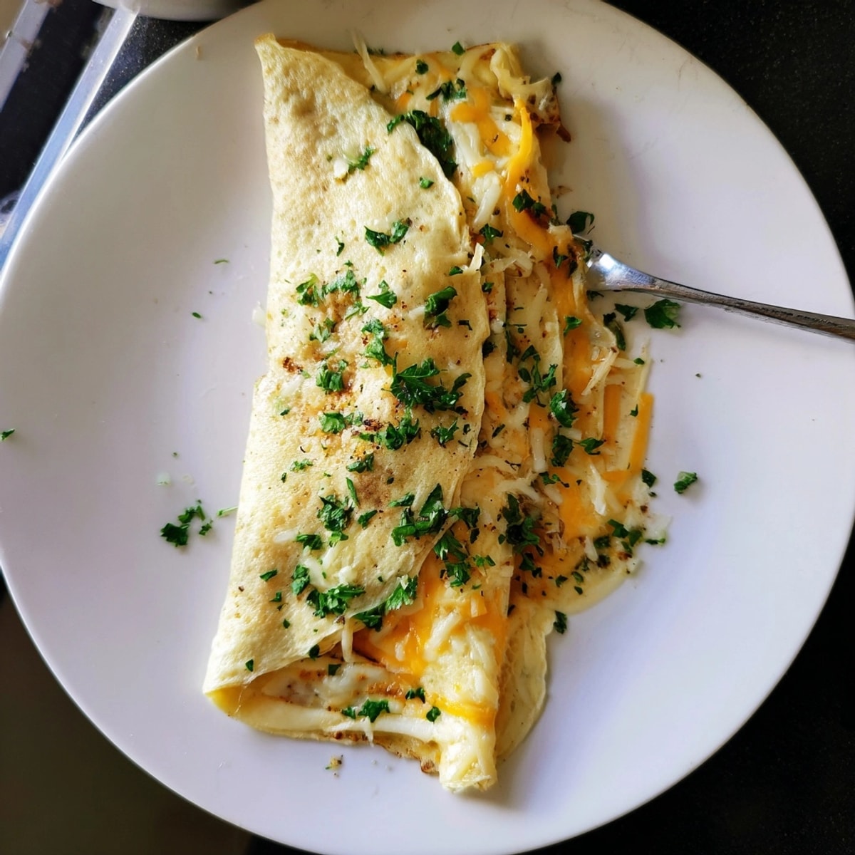 Golden Cheesy Garlic Tortilla Omelette, folded warm, with melted cheese, perfect for brunch.