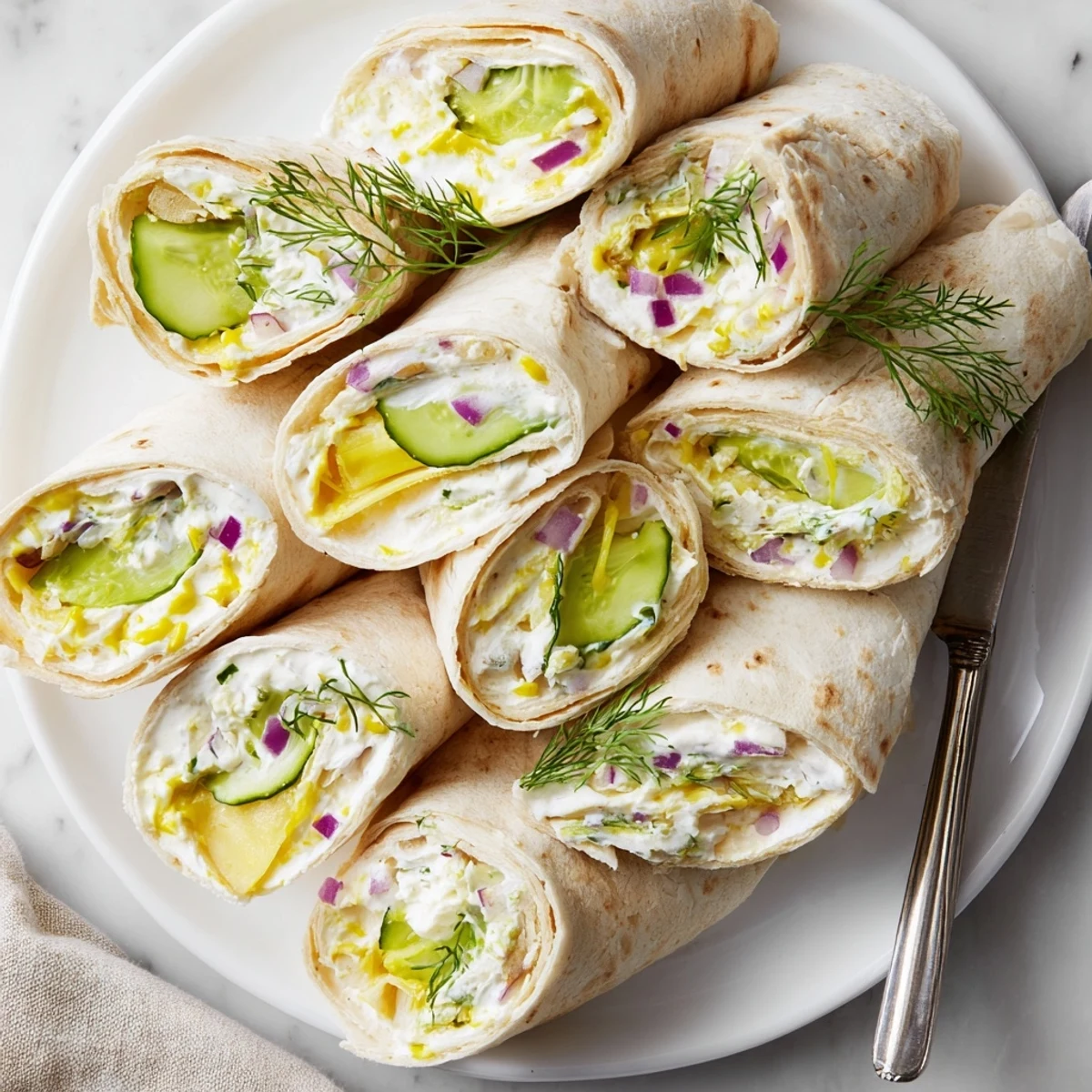 Tangy Pickle-in-a-Blanket wrapped in soft tortillas and creamy cheese delight.  