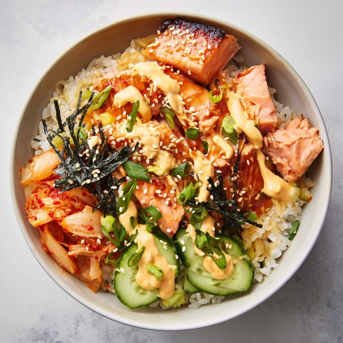 Flavorful crispy salmon rice bowl featuring fresh veggies and creamy avocado slices.
