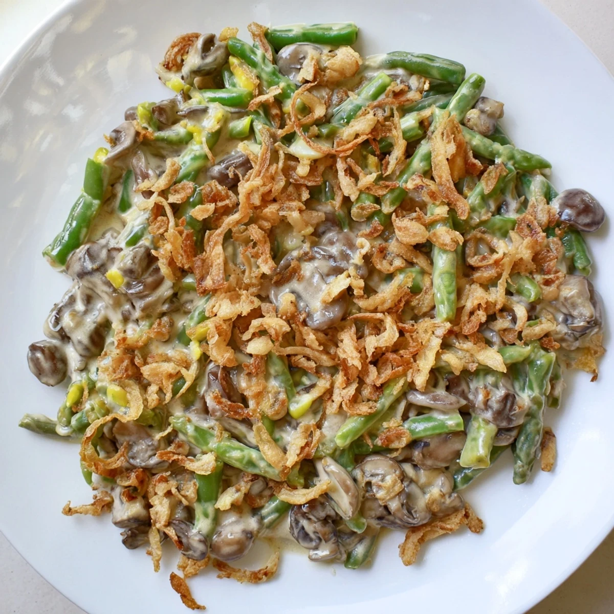 Classic Old-School Green Bean Casserole, bubbling hot, topped with crispy fried onions for a festive dinner.