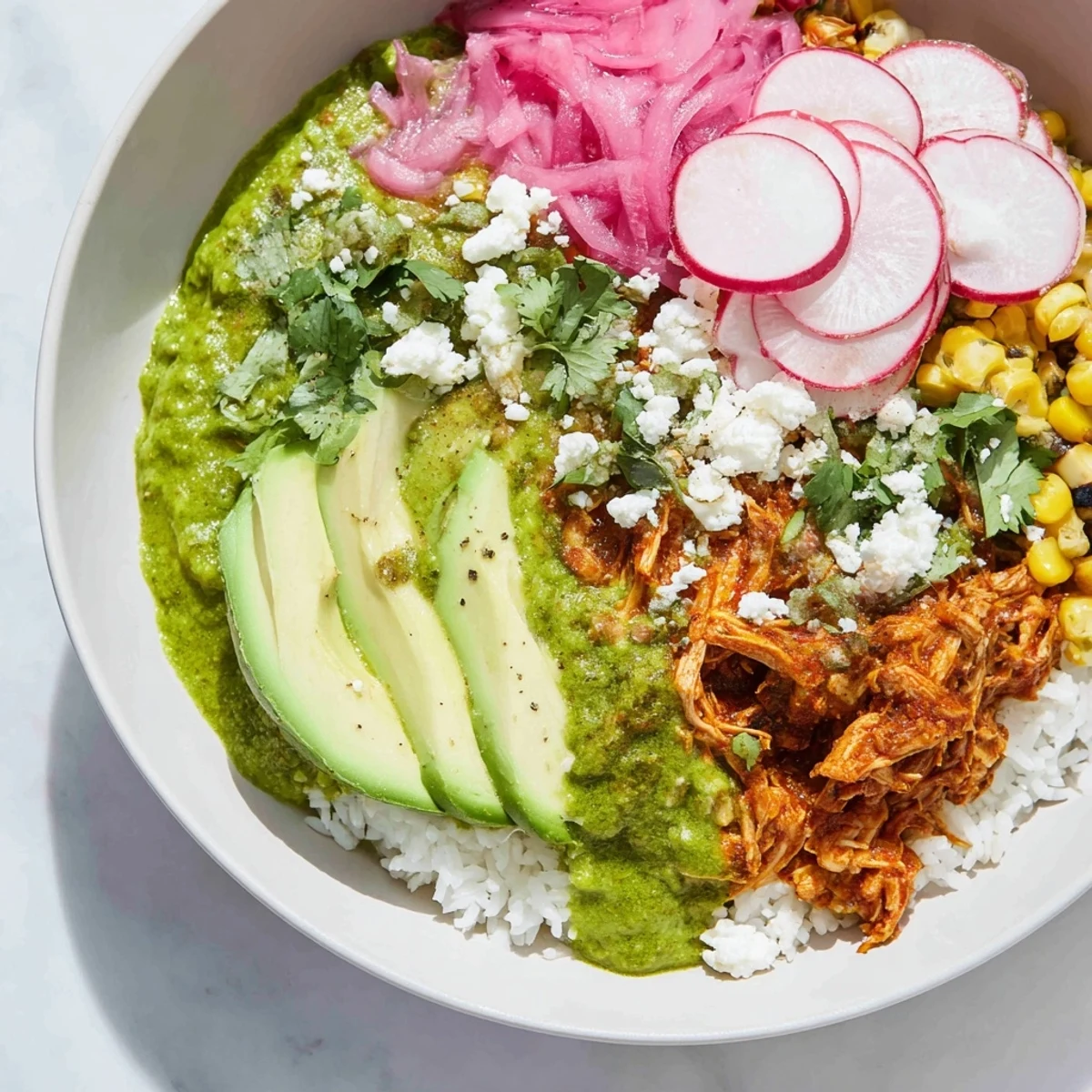 Tempting Green Enchiladas Rice Bowl overflowing with vibrant cilantro, avocado, and creamy cheese, ready to enjoy.