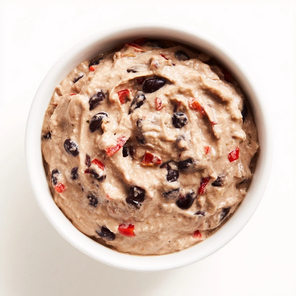 Creamy, vibrant spicy black bean dip served with crispy tortilla chips for dipping fun.