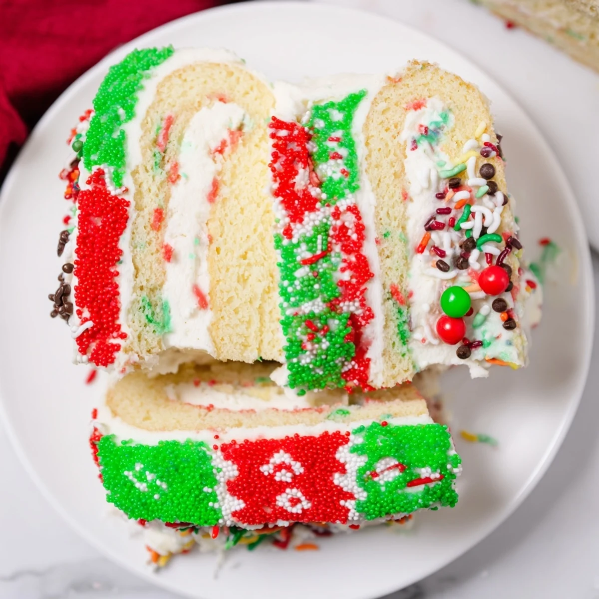 Sweet Ugly Sweater Cake Roll showcasing colorful frosting patterns and a sprinkle-covered presentation, delicious and fun.