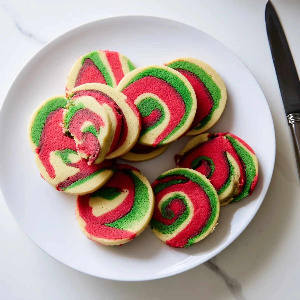 Close-up of baked Holiday Pinwheel Cookies, with beautiful colors and textures, perfect for a cookie exchange.