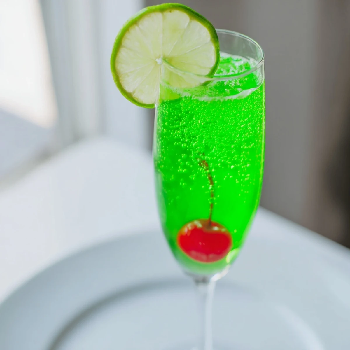 A refreshing Quick Grinch Mimosa Mocktail with bubbly lemon-lime soda, ready to serve and enjoy.