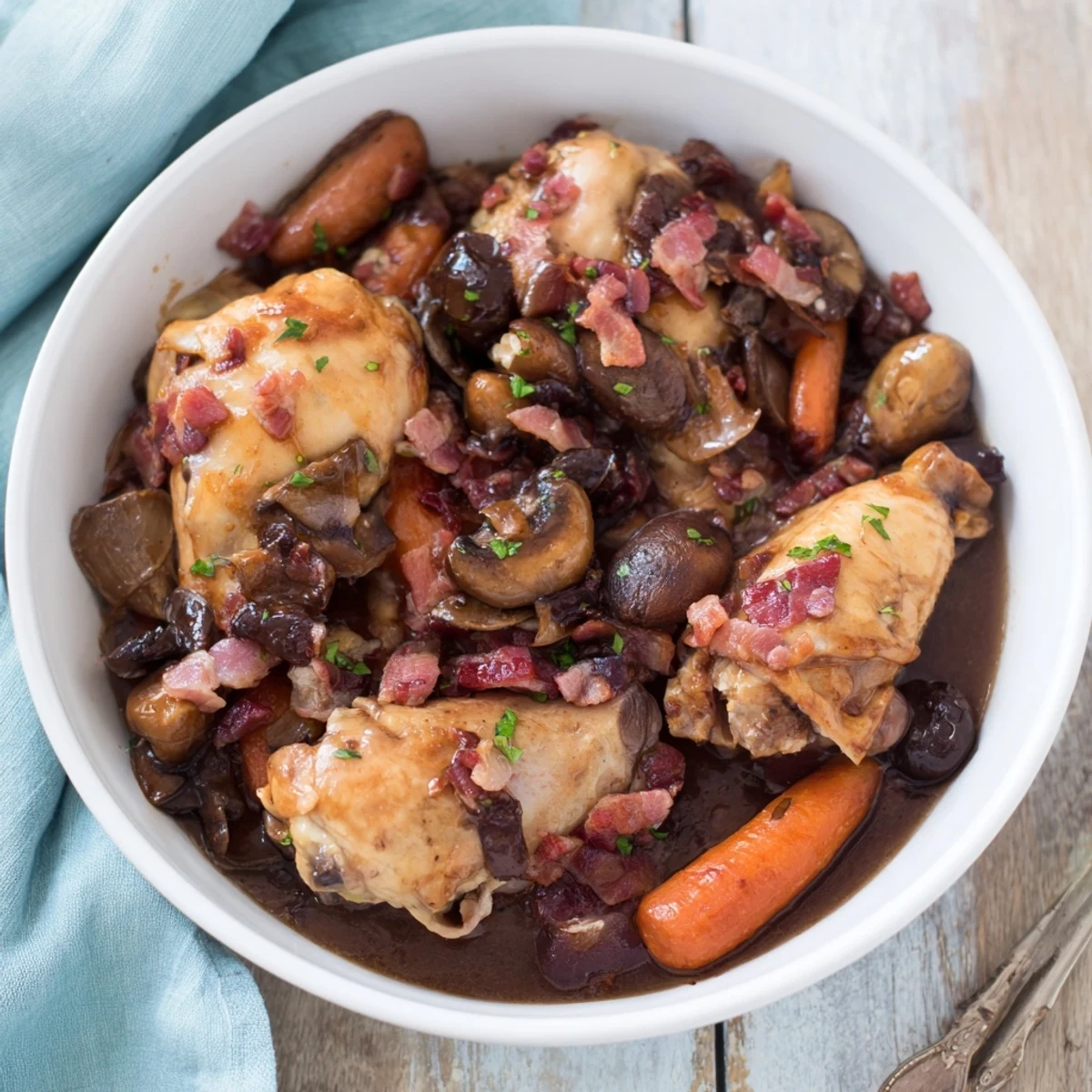 Tender Instant Pot Coq au Vin Style Chicken Thighs with rich red wine sauce and savory bacon.