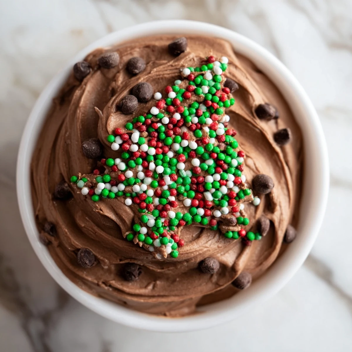 Festive Tree Brownie Dip, swirled and topped with holiday sprinkles, is perfect for dipping graham crackers.