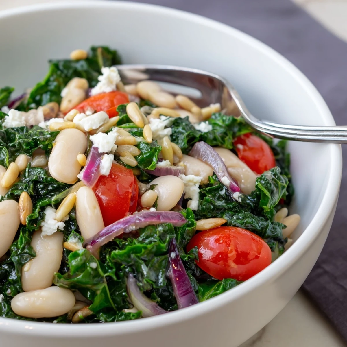 This White Bean and Kale Salad features massaged kale, creamy beans, and a bright lemon-garlic dressing, topped with toasted sunflower seeds.