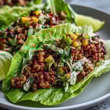 Fresh mango slaw and spicy turkey fill butter lettuce leaves for Skinny Spicy Turkey Lettuce Tacos with Mango Slaw.