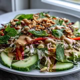 Colorful Vegan Spring Roll Salad with rice noodles, crisp veggies, and herbs drizzled with a zesty peanut dressing.