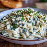 Gooey Spinach Artichoke Orzo, a comforting vegetarian pasta dish perfect for dinner.