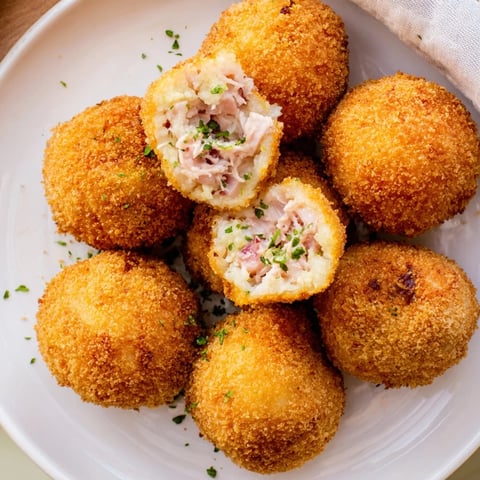 Golden, crispy Creamy Chicken & Rice Arancini Balls ready to be served, a satisfying Italian appetizer.
