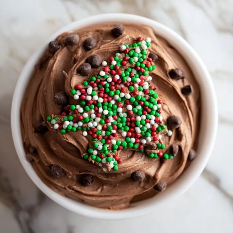 Festive Tree Brownie Dip, swirled and topped with holiday sprinkles, is perfect for dipping graham crackers.