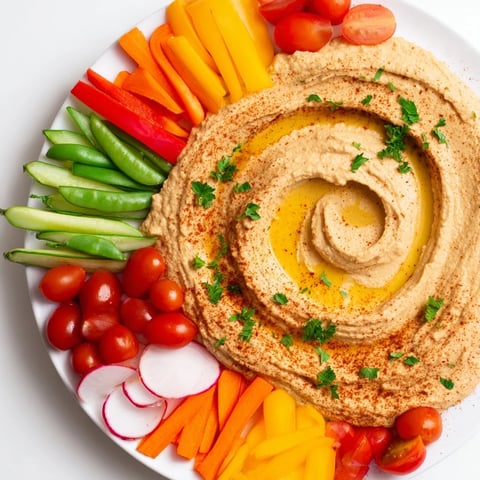 Vibrant River Delta Flow appetizer with colorful fresh veggies cascading into hummus, ready to enjoy.