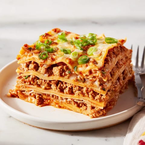 Delicious Spicy Ramen Lasagna featuring vibrant noodles and spicy pork filling.  