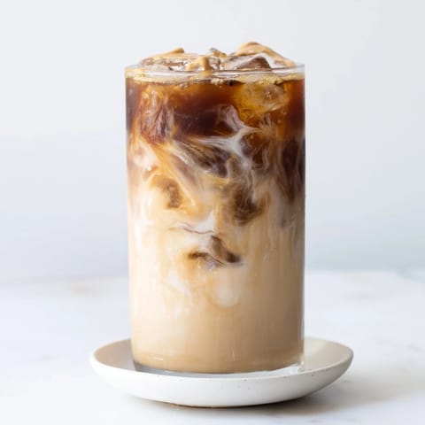 Refreshing cold brew blended with tahini and plant-based milk for summer sipping.  