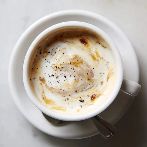Savory Onion Latte blending rich espresso and sweet caramelized onions, perfect for adventurers.  