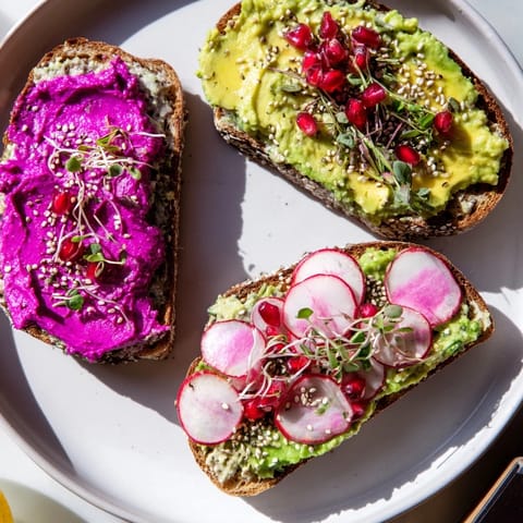 Colorful Bright & Bold Breakfast Toasts featuring creamy avocado and pomegranate seeds.  