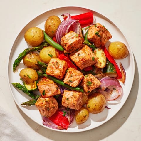 This hearty Salmon & Potato Skillet recipe features perfectly cooked salmon alongside vibrant veggies.