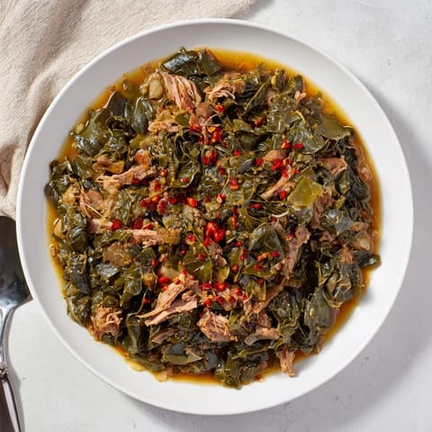 Savory Southern style collard greens with smoked turkey, featuring vibrant greens and tender meat.