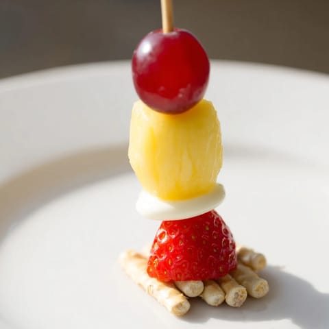 Christmas Light Fruit Skewers bursting with colorful berries and pineapple, perfect for a cheerful holiday snack.