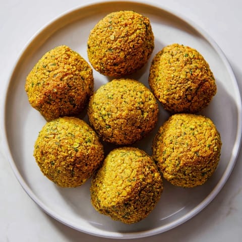 Imagine the aroma: hot, freshly fried Levantine falafel balls, tempting with herbs and spices inside.