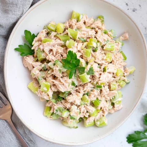 Savory Spicy Zesty Tuna Salad served in crisp lettuce cups, topped with fresh herbs for a light lunch.