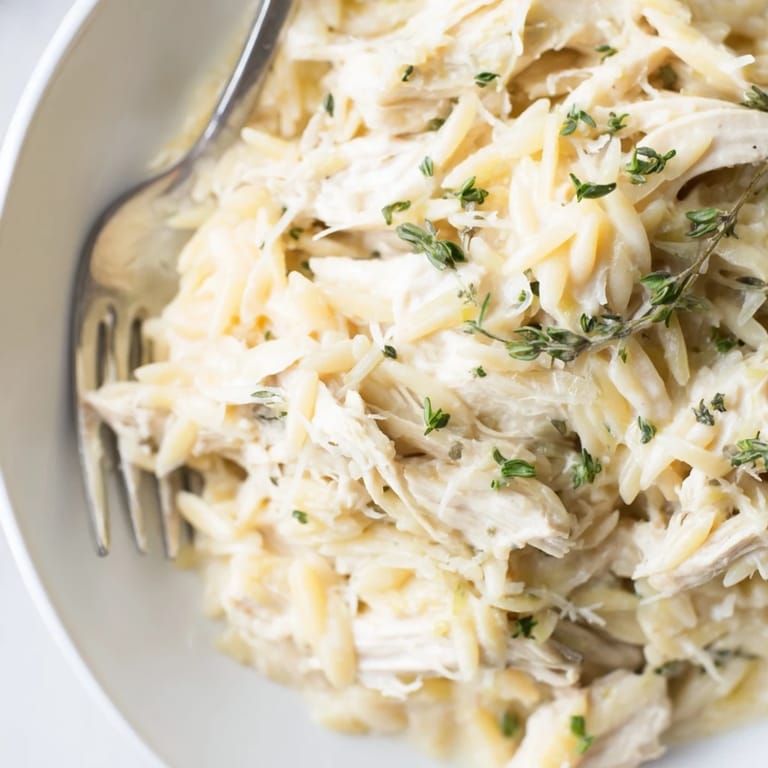 Delicate Creamy Lemon Herb Chicken Orzo, blending rich creaminess with zesty lemon flavor.