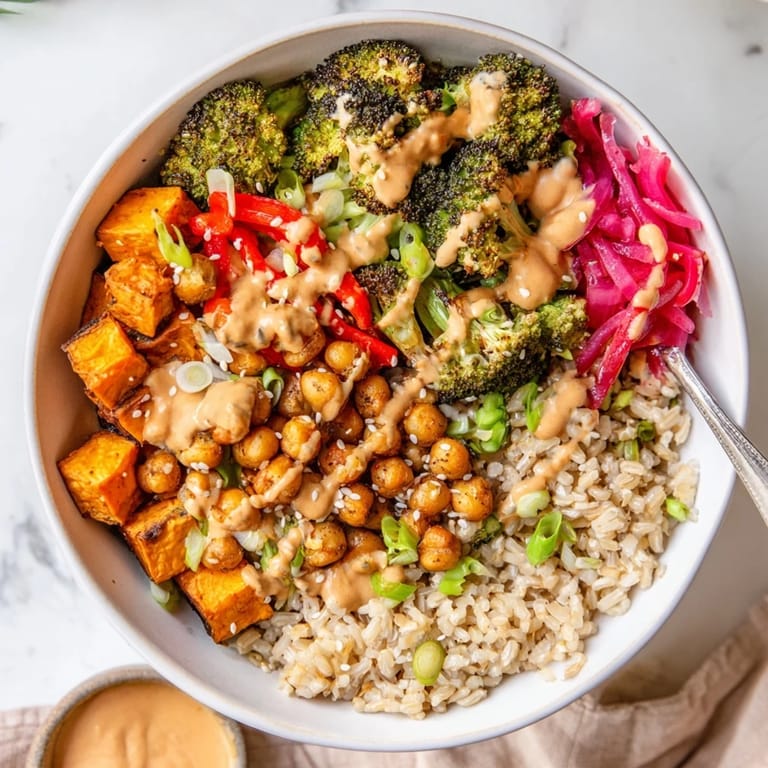 Hearty Bold Sauce Drizzle Bowls featuring crispy chickpeas and fresh toppings, deliciously customizable.