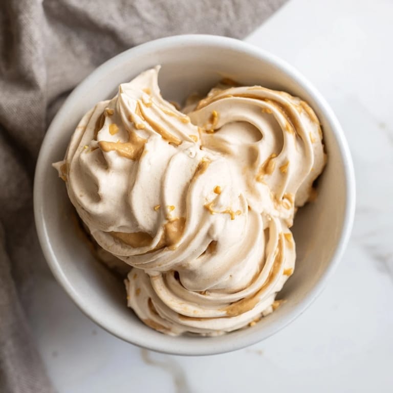Frozen bananas and peanut butter transformed into decadent Peanut Butter Banana Ice Cream, perfectly chilled.