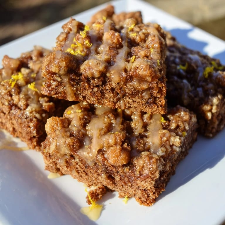 Close-up of freshly baked Lemon-Glazed Gingerbread Crumble Bars—a delicious dessert with a rich flavor profile.