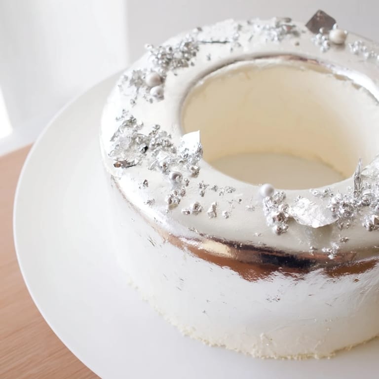 This Diamond Ring Engagement Cake showcases layers of white chocolate, creating a dazzling dessert for special events.