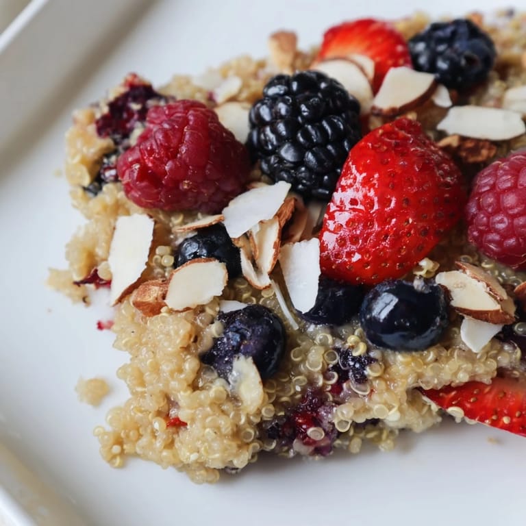 Juicy mixed berries peek through the baked top of this comforting Berry Quinoa Breakfast Bake.