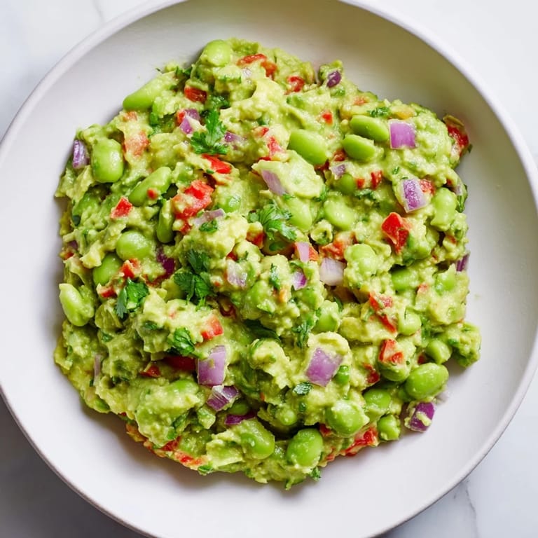 Freshly made Edamame Guacamole, served with tortilla chips, ready for dipping and enjoying.