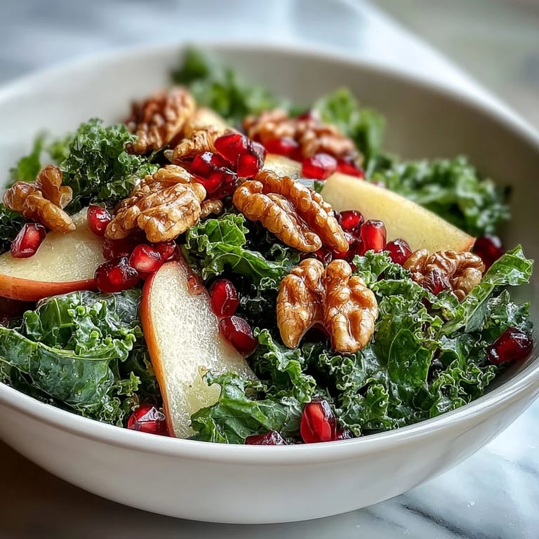 Ready in minutes, this Kale and Pomegranate Bowl features hearty kale, sweet-tart seeds, and crunchy walnuts tossed in apple cider vinaigrette.